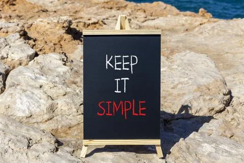 Keep it simple symbol. Concept word Keep it simple on beautiful black chalk.. Stock Photos