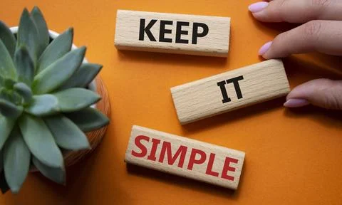 Keep it Simple symbol. Concept words Keep it Simple on wooden blocks. Busin.. Stock Photos