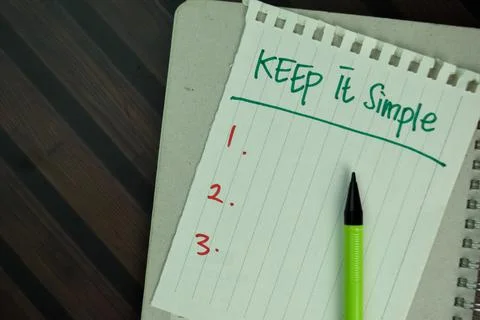 Keep it Simple write on sticky notes isolated on Wooden Table. Stock Photos