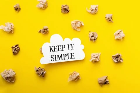 Keep it simple is written in bold black text on a bright yellow background Stock Photos