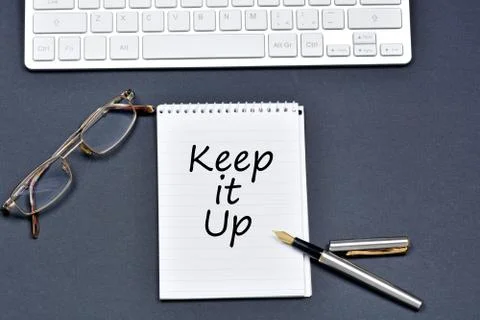 Keep it up text on notebook Stock Photos