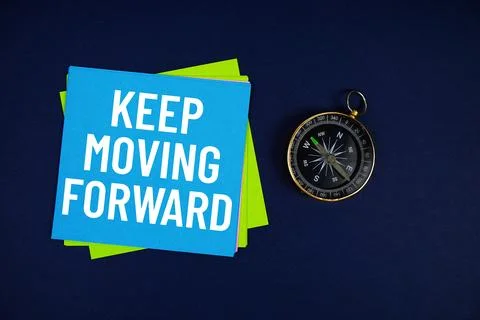 Keep Moving Forward text written on sticky note with compass on blue  backg.. Stock Photos