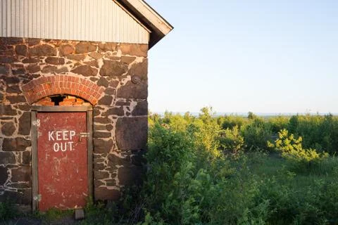 Keep Out Sign Stenciled on Rustic Red Door Stock Photos
