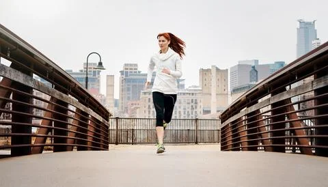 Keep pushing on and youll soon conquer. a sporty young woman listening to music Stock Photos