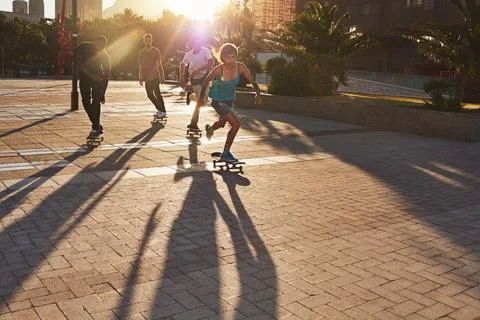 Keep on pushing. a group of skaters skating in the city. Stock Photos