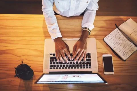 Keep on pushing through those deadlines. High angle shot of an unrecognizable Stock Photos