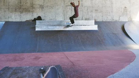 Keep on pushing. a young man doing tricks on his skateboard at the skatepark. Stock Photos