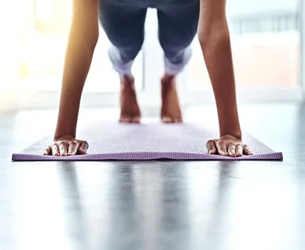 Keep pushing yourself to be better. an unrecognizable woman doing push-ups. Stock Photos