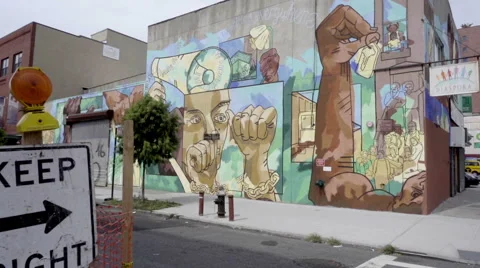 Keep right traffic sign and Diaspora mural in Brooklyn NYC Stock Footage 67863962