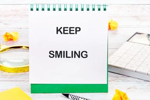 KEEP SMILING written on a desktop notebook with decorative elements such as a 库存照片