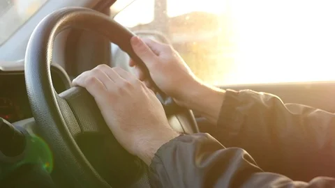 Keep the steering wheel close-up with beautiful lighting from the sunset between Stock Footage 81714093