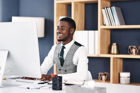 Keep striving, keep growing. Shot of a young businessman using a computer at  Stock Photos