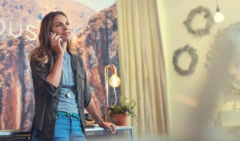 Keep in touch and keep loyal customers happy. a young woman using a mobile phone Stock Photos