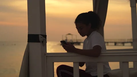 Keep in touch. Young woman using smartphone, scrolling news feed while watching Stock Footage 149434628