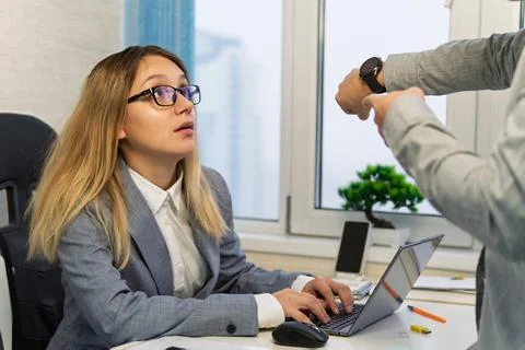 Keep track of time. man point at clock. being late at work. The boss scolds.. Stock Photos