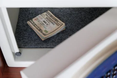 Keep us dollars in a safe place in the office or at home. Money under lock an Stock Photos