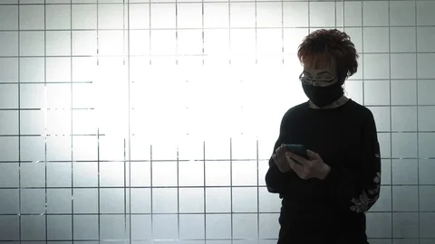 Keep your distance during a pandemic. Elderly woman in protective masks stops in Stock Footage 128221736