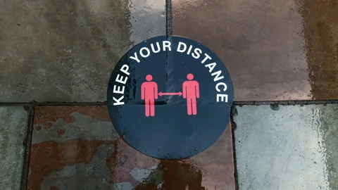 A "keep your distance" pavement sticker, social distancing sign. Stock Footage 145549166