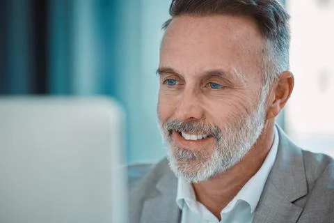 Keep your face always toward the sunshine. a mature man using a computer at work Stock Photos