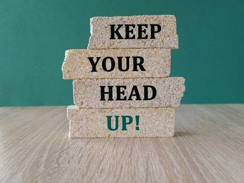 Keep your head up symbol. Concept words Keep your head up on brick blocks. Stock Photos