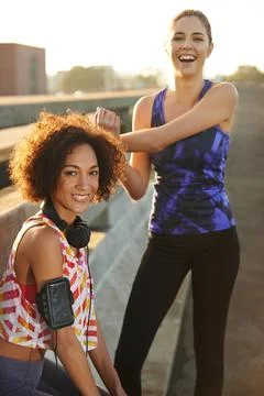 Keeping fit and laughing the whole time. Portrait of two female joggers Stock Photos