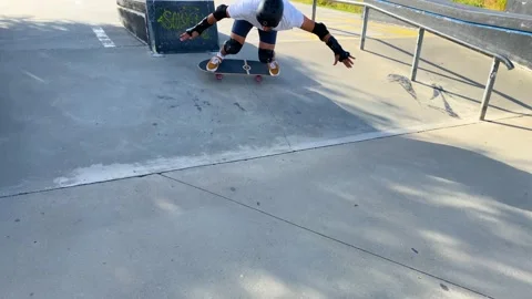 Keeping a Low Center of Gravity to do backside tailslide using skateboard Stock Footage 196721226