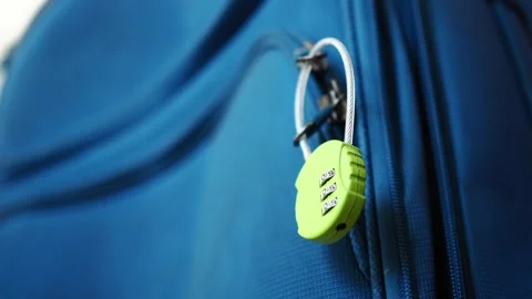 Keeping luggage secure with a combination lock on a blue suitcase Stock Footage 346583201
