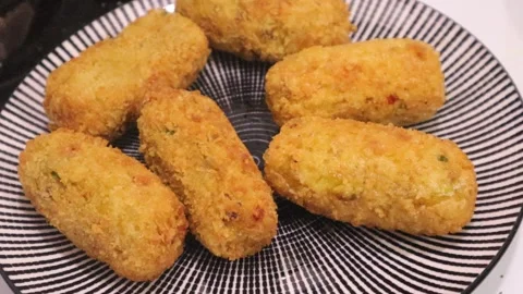 Keeping in plate Crispy breaded potato snacks after fried  Stock Footage 328723917