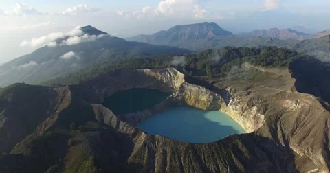 Kelimutu volcano crater with three multicoloured lakes - Aerial pan Stock Footage