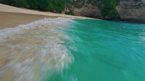 Kelingking Beach close to the waves FPV Drone Stock Footage 276832492
