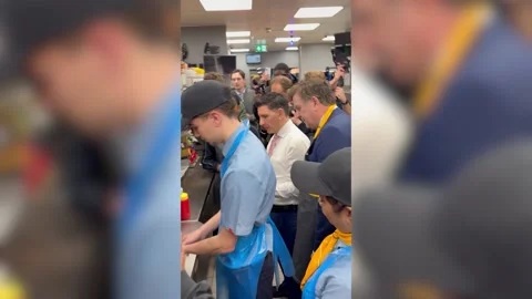 Kemi Badenoch makes an Egg McMuffin during McDonald's visit Stock Footage 328580722