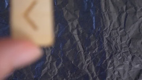 Kenaz rune. close-up, hand puts the rune on the surface for divination. 4k, slow Stock-Footage 87879708