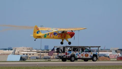 Kent Pietsch tries to Land His Interstate Cadet on a Moving Truck at an Airshow Stock Footage 110744461