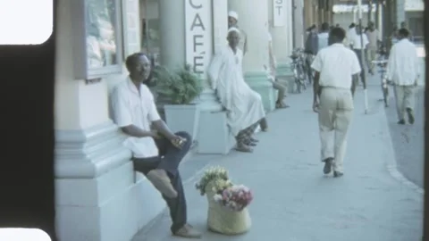 Kenya 1970s, Footpath view with people beside street in Mombasa Stock Footage 313508099