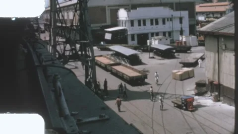 Kenya 1970s, port workers unloading cargo from ship at dockside 動画素材 313779096