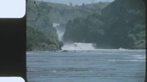 Kenya 1970s, View of waterfall surrounded by tree covered hills Stock Footage 313782474