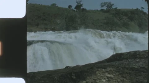 Kenya 1970s, Waterfall view surrounded by rock object and green landscapes Vidéo 313782396