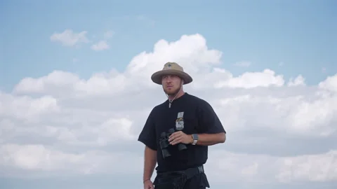 Kenya - 26 September 2025 Explorer Using Binoculars on African Safari Kenya Stock Footage 320723646