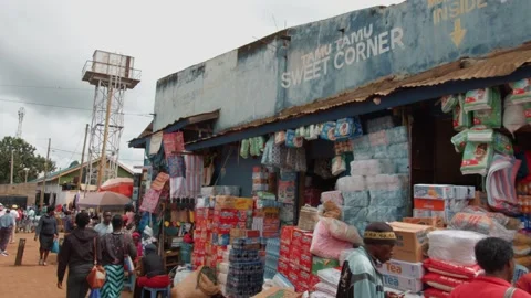 Kenya, Kitale - May 3, 2025: African men and women shop at local market where Video stock 312725931