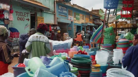 Kenya, Kitale - May 3, 2025: African man works at local market and sells plastic 動画素材 312726090