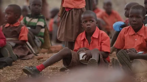 Kenya, Loima - May 5, 2025: Group of african schoolchildren sit on ground and Video stock 311040367