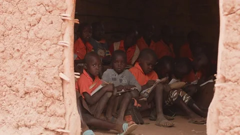 Kenya, Loima - May 5, 2025: African schoolkids study sitting on boards on floor Stock Footage 311918896