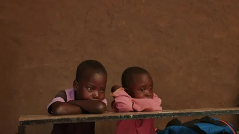 Kenya, Loima - May 5, 2025: Portrait of two cute little african children sitting Video stock 313038587