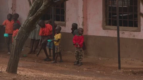 Kenya, Loima - May 5, 2025: African children stand under canopy of house and Stockbeeldmateriaal 313038778