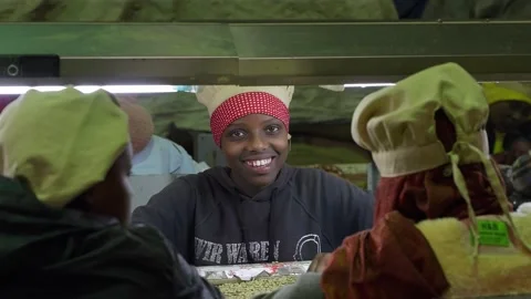 Kenya, Nakuru, May 20 2024 Smiling Worker Sorting Coffee Beans at Factory Line Stock Footage 300338341