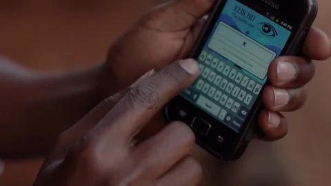 Kenyan using local smartphone app - close up - depth of field Stock Footage 72278073