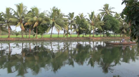 Kerala backwaters canoe and reflections s Stock Footage 24279226