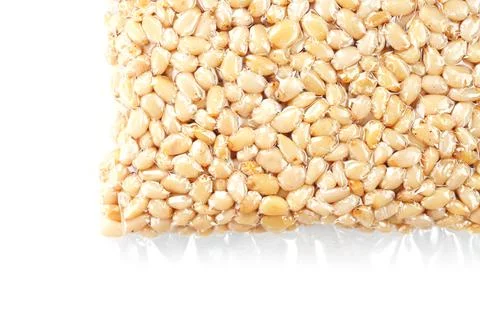 Kernels of peeled pine nuts in vacuum packaging on a white background Foto stock