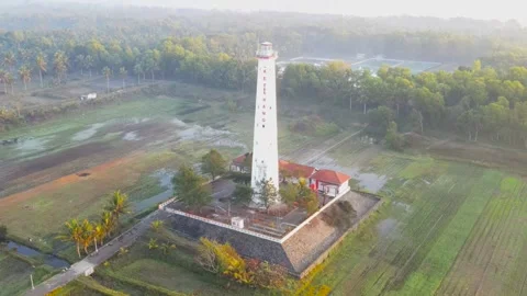 Ketawang beach Lighthouse in Central Java. Aerial tilt up view Stock Footage 249665674