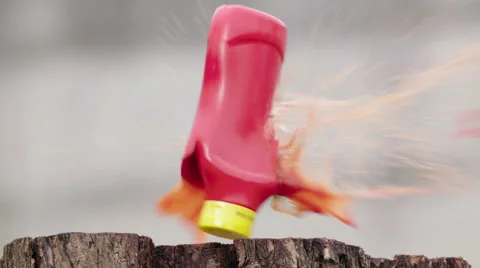 Ketchup bottle gun shot in native slow motion scene Stock Footage 64019941